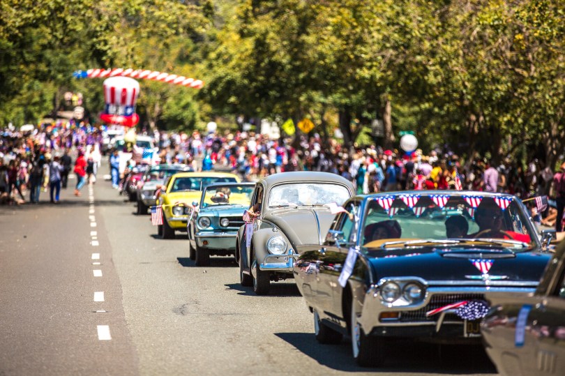 Cars with flags in the foreground, Uncle Sam hat in background at Thomas Hawk 50th Annual Piedmont 4th of July Parade, Piedmont, California | CC-BY-NC Thomas Hawk