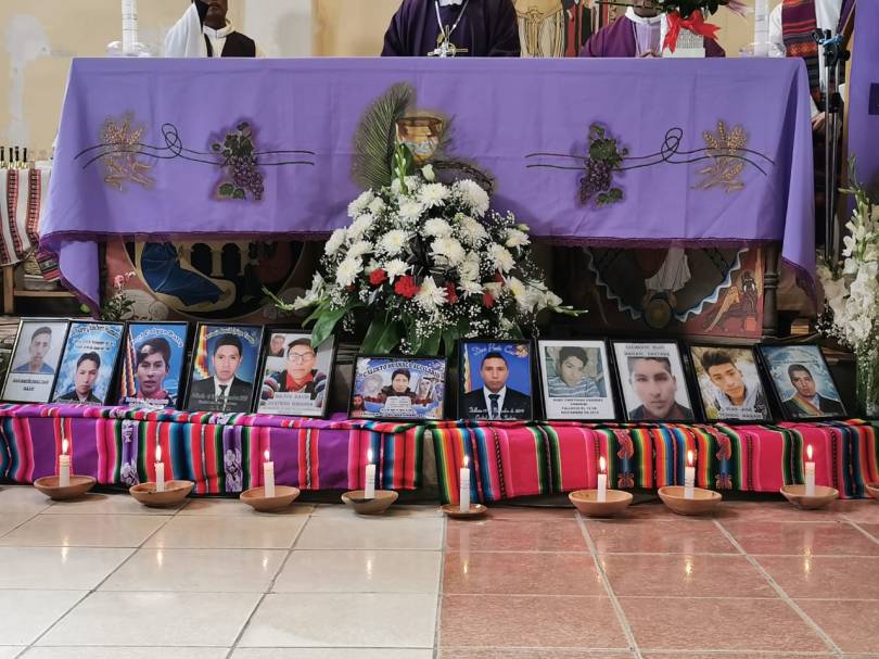 Photos of Senkata massacre victims laid out before a mass table on March 5, 2020